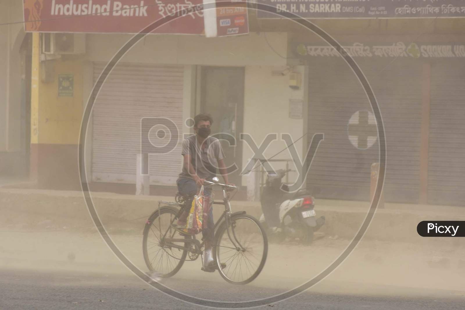 A Man Rides A Bicycle During Massive Dust Storm  During A Nationwide Lockdown In The Wake Of Corona virus or COVID-19  Pandemic, In  Nagaon District Of Assam On April 15,2020.