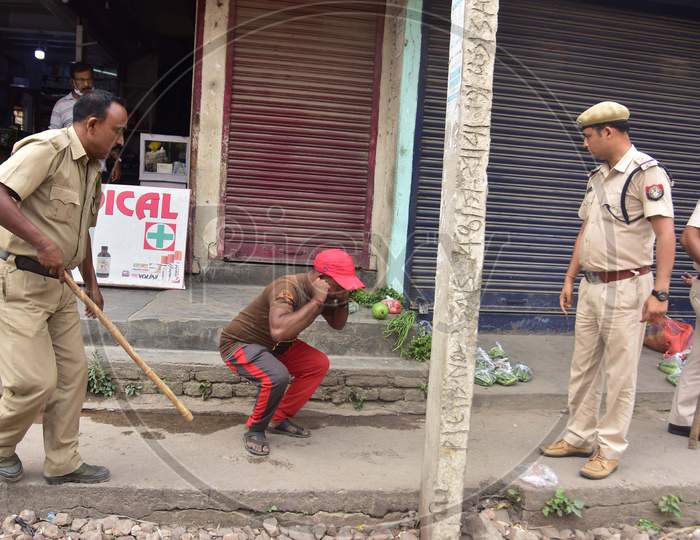 A Police Officer  Punish  A Man  For Breaking The Lockdown Rules During A Nationwide Lockdown In The Wake Of Corona virus or COVID-19  Pandemic, In  Nagaon District Of Assam On April 15,2020.