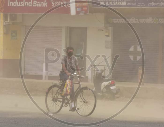 A Man Rides A Bicycle During Massive Dust Storm  During A Nationwide Lockdown In The Wake Of Corona virus or COVID-19  Pandemic, In  Nagaon District Of Assam On April 15,2020.