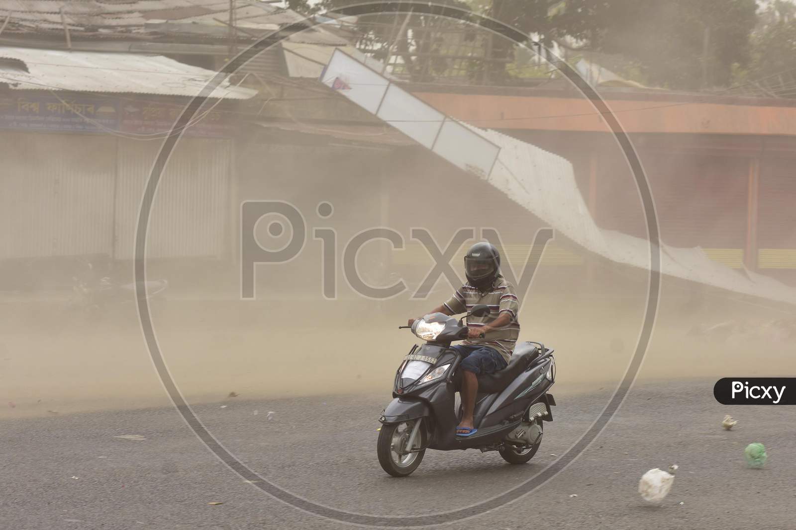 A Man Rides A Bike During Massive Dust Storm  During A Nationwide Lockdown In The Wake Of Corona virus or COVID-19 Pandemic, In  Nagaon District Of Assam On April 15,2020.