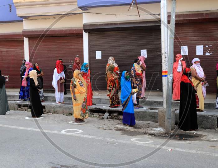 Women Standing Outside  A Bank to Withdraw Money During A Nationwide Lockdown To Slow The Spreading Of The Coronavirus Disease (Covid-19), In Prayagraj, April, 15, 2020.