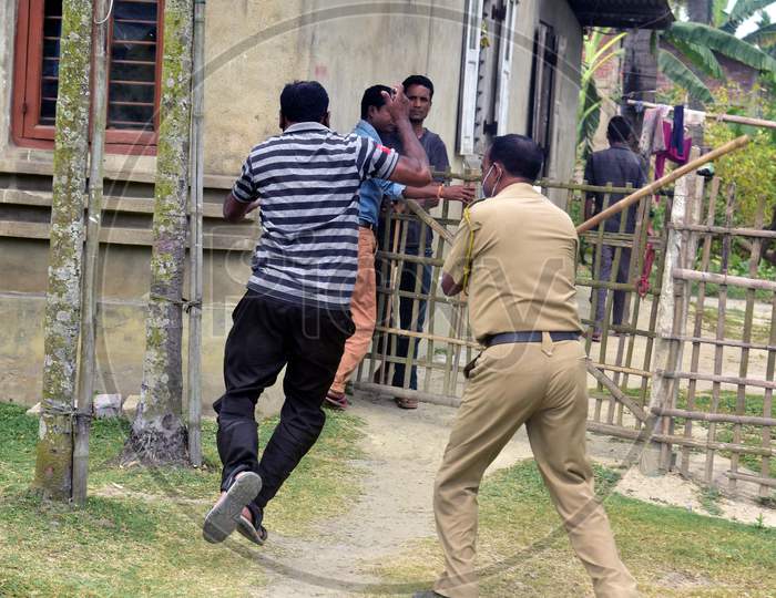 A Police Officer Wields His Baton Against Man As A Punishment For Breaking The Lockdown Rules During A Nationwide Lockdown In The Wake Of Corona virus  or COVID-19 Pandemic, In  Nagaon District Of Assam On April 15,2020.