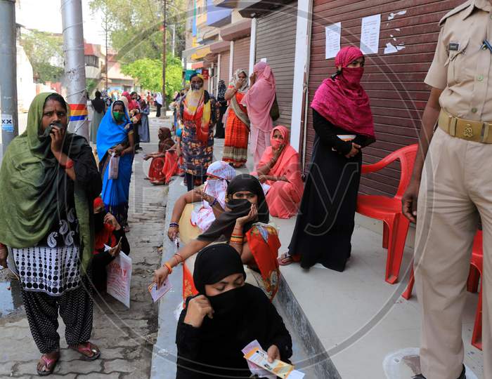 Women Standing Outside A Bank to Withdraw Money During A Nationwide Lockdown To Slow The Spreading Of The Coronavirus Disease (Covid-19), In Prayagraj, April, 15, 2020.