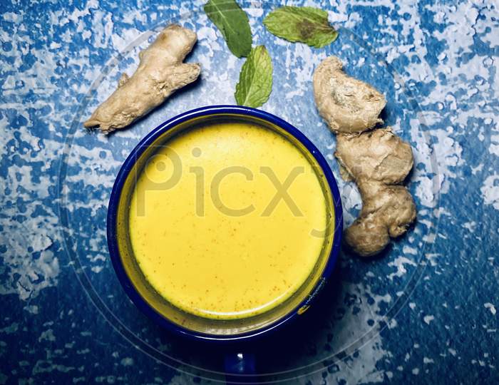 Turmeric milk, ginger and some tulsi leaves
