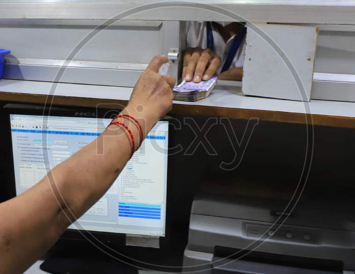 A Bank Employee Sanitizes Indian Currency Inside A Bank During A Nationwide Lock down To Slow The Spreading Of The Corona virus Disease (Covid-19), In Prayagraj, April, 16, 2020.