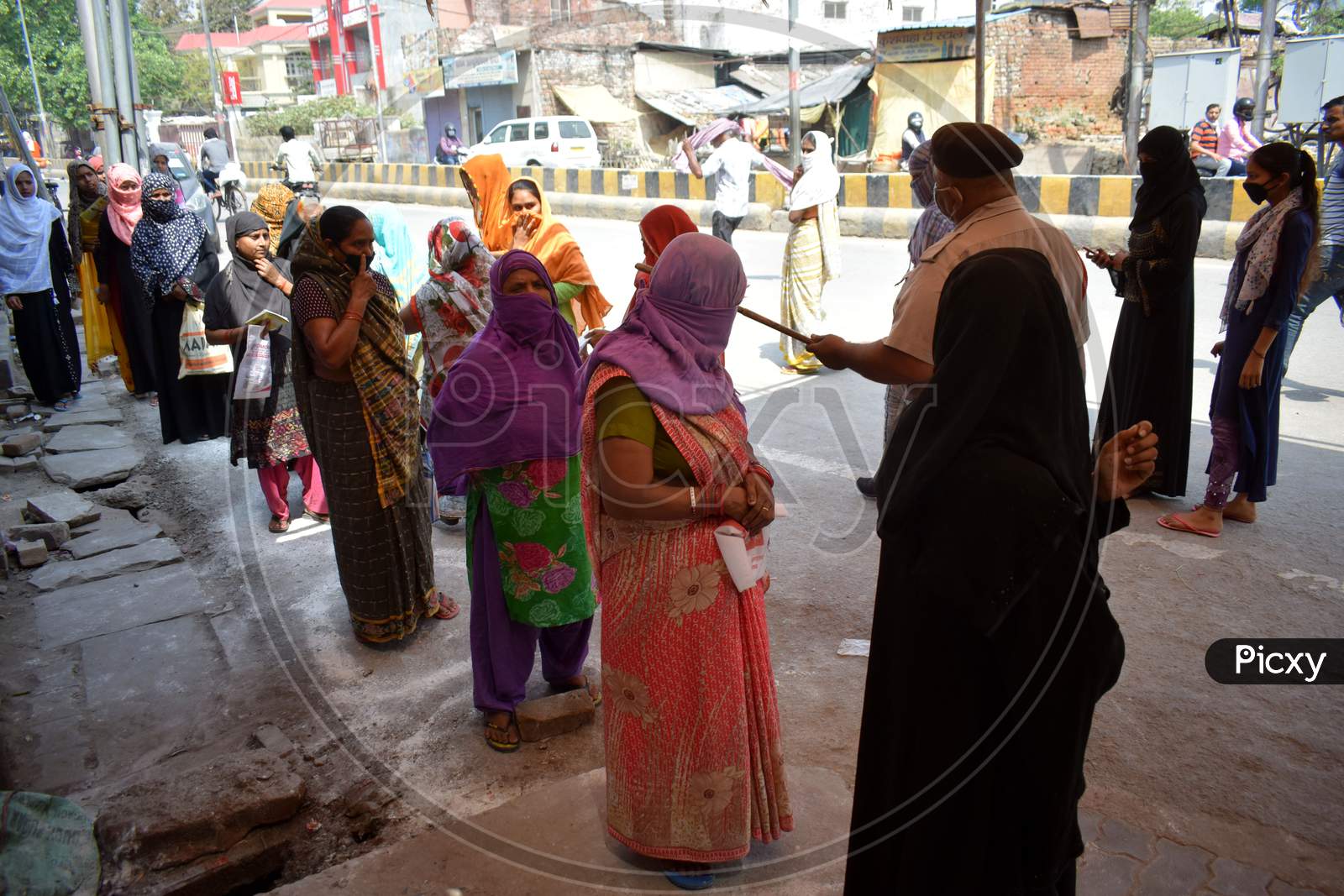 Beneficiaries Lined Up Outside A Ration Shop To Collect Free Food Grains State Government Schemes To Poor People Amid The Complete Lockdown In The Wake Of The Cororavirus  or COVID-19 Pandemic, In Prayagraj, Wednesday, April 15, 2020.