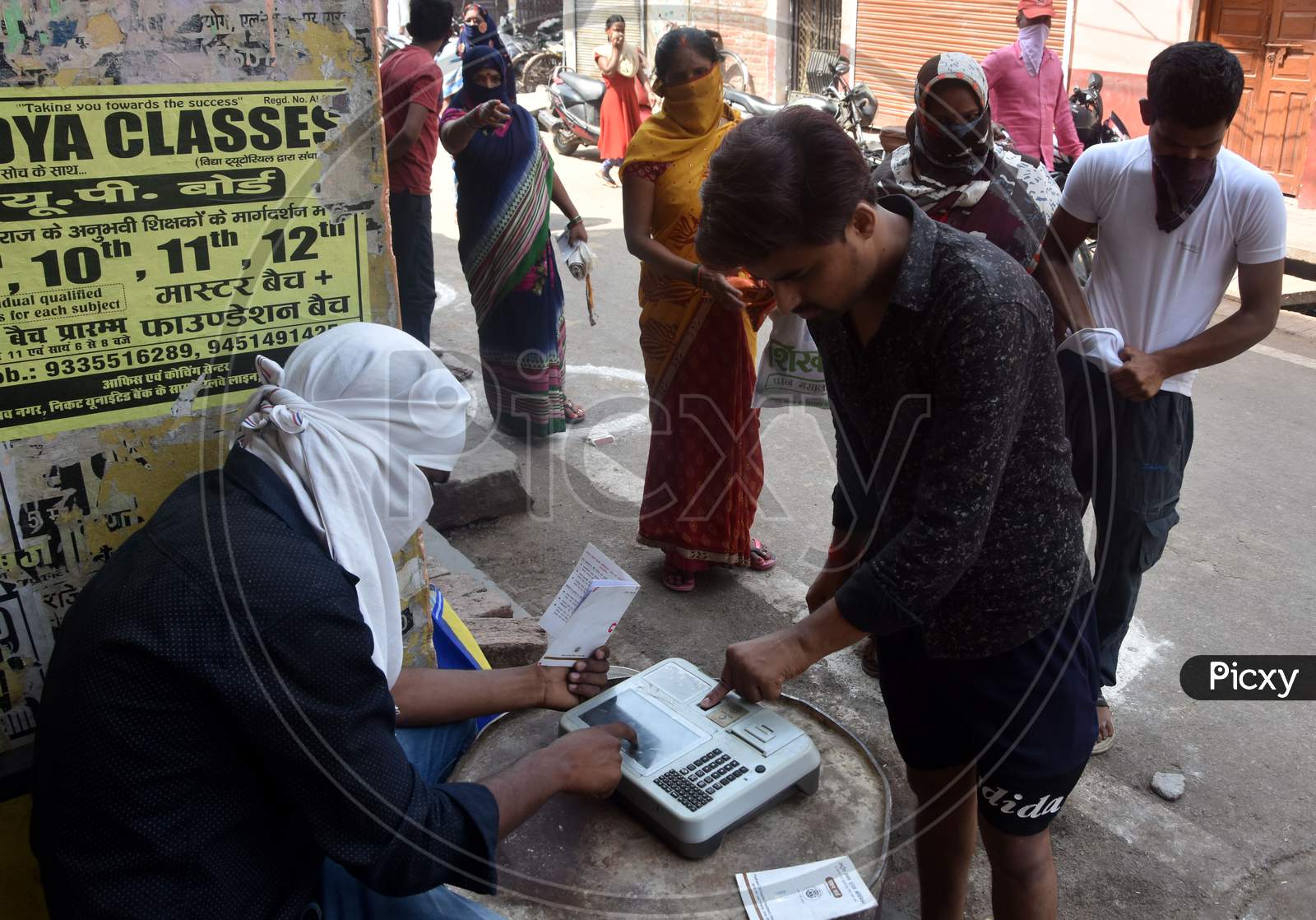 Beneficiaries Lined Up Outside A Ration Shop To Collect Free Food Grains From State Government Schemes To Poor People Amid The Complete Lockdown In The Wake Of The Cororavirus  or COVID-19 Pandemic, In Prayagraj, Wednesday, April 15, 2020.