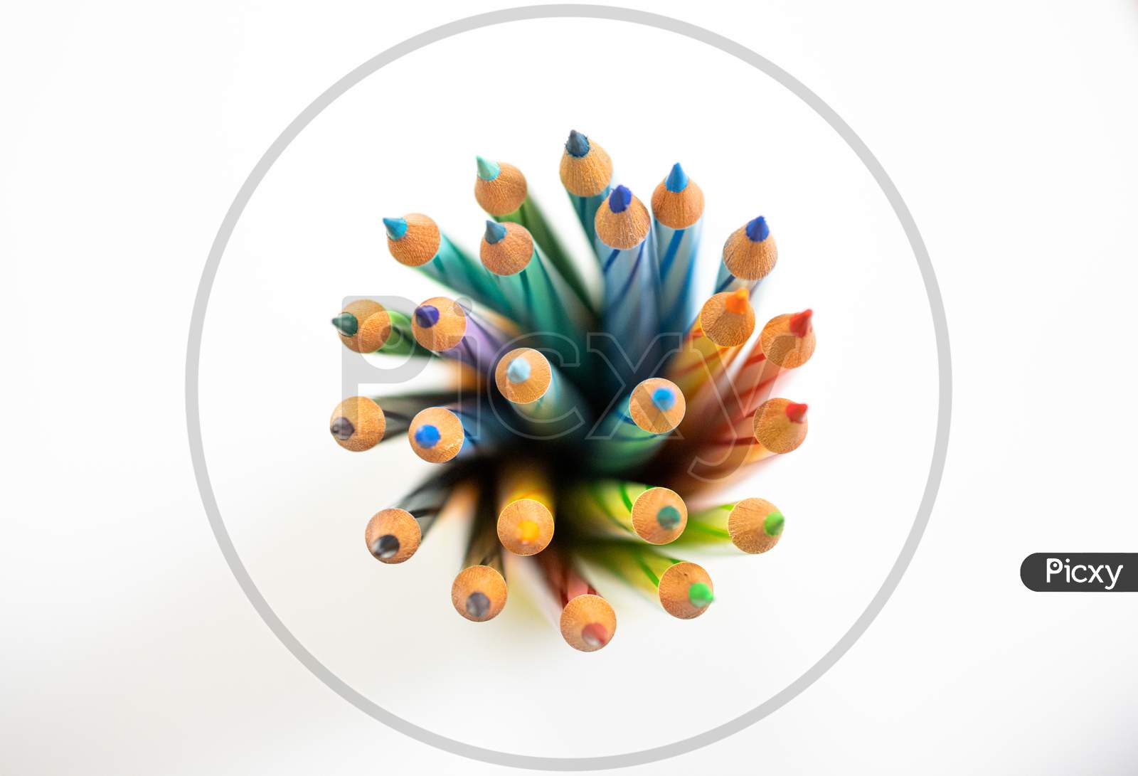 Color Pencils arranged in circular motion On white Background Showing Unity