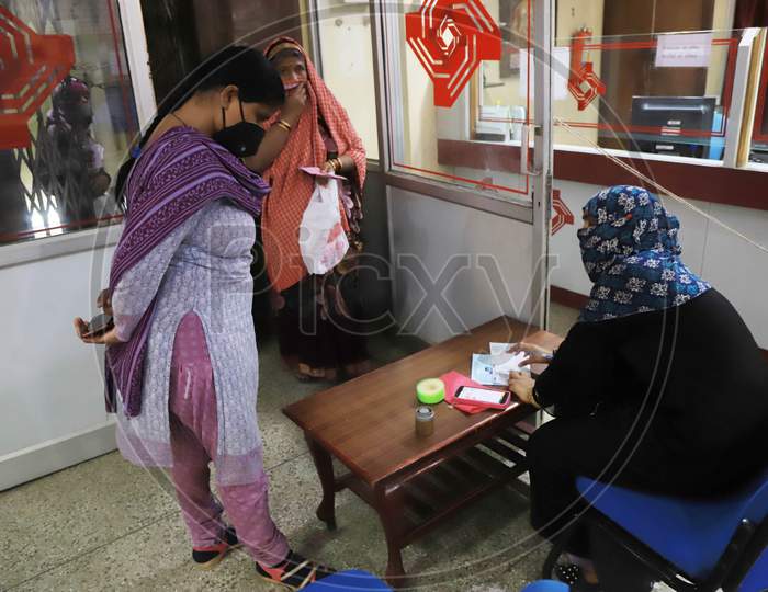 A Woman Filling Form To Withdraw The Money Inside A Bank During A Nationwide Lockdown To Slow The Spreading Of The Coronavirus Disease (Covid-19), In Prayagraj, April, 16, 2020.