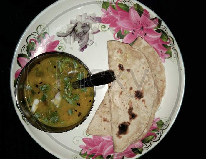 Dal roti, chapati and Sabji on plate isolated with Black background