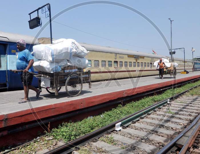 Men Pulling  Loaded  Hand Cart At a Railway station During a Nation Wide Lock down For Corona Virus Or COVID-19 Pandemic In Guwahati, India . April 16,2020