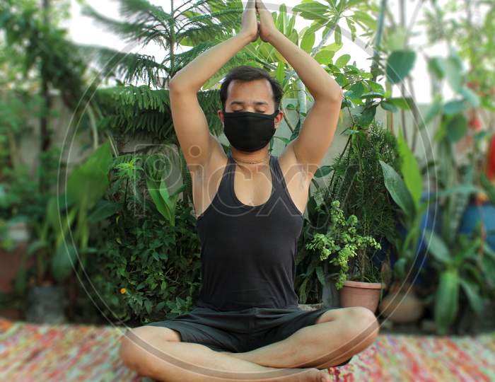 meditation with protective mask during lockdown due to covid-19, coronavirus