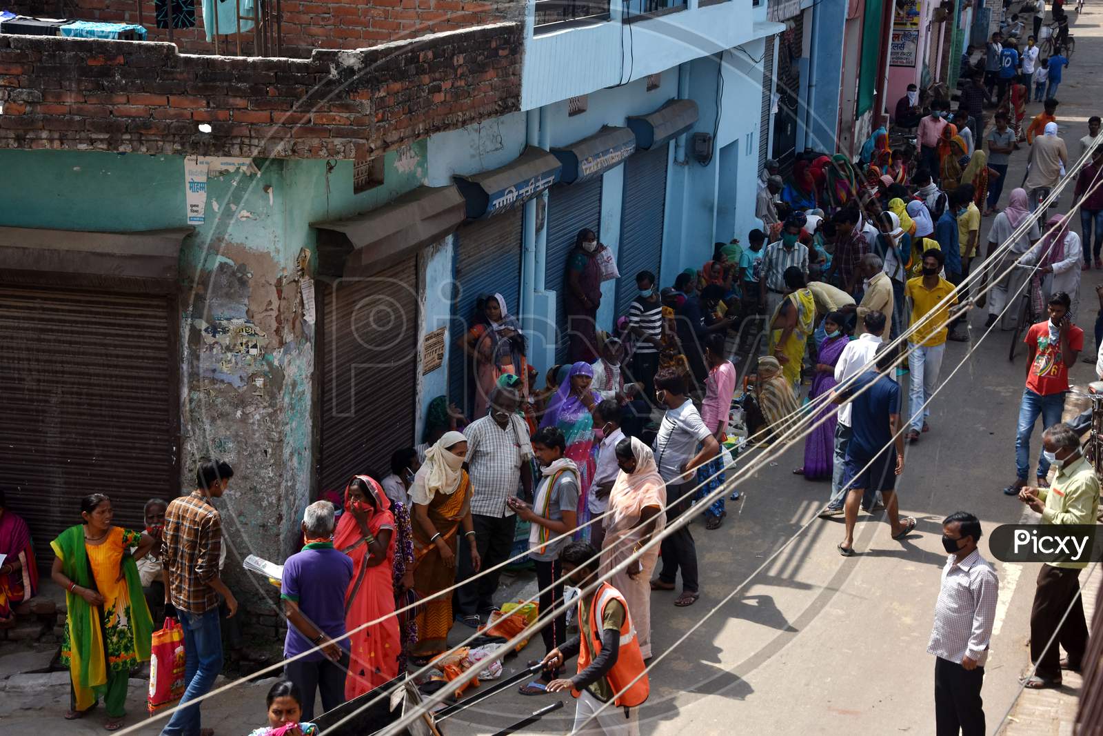 Beneficiaries Lined Up Outside A Ration Shop To Collect Free Food Grains From State Government Schemes To Poor People Amid The Complete Lockdown In The Wake Of The Cororavirus  or COVID-19 Pandemic, In Prayagraj, Wednesday, April 15, 2020.