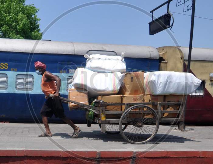 A Man Pulling  Loaded  Hand Cart At a Railway station During a Nation Wide Lock down For Corona Virus Or COVID-19 Pandemic In Guwahati, India . April 16,2020