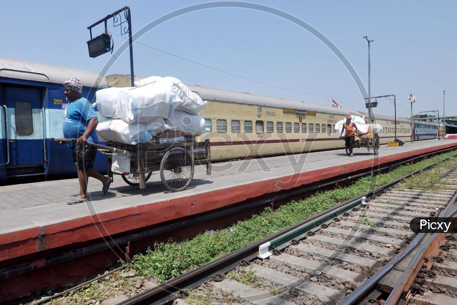 Men Pulling  Loaded  Hand Cart At a Railway station During a Nation Wide Lock down For Corona Virus Or COVID-19 Pandemic In Guwahati, India . April 16,2020