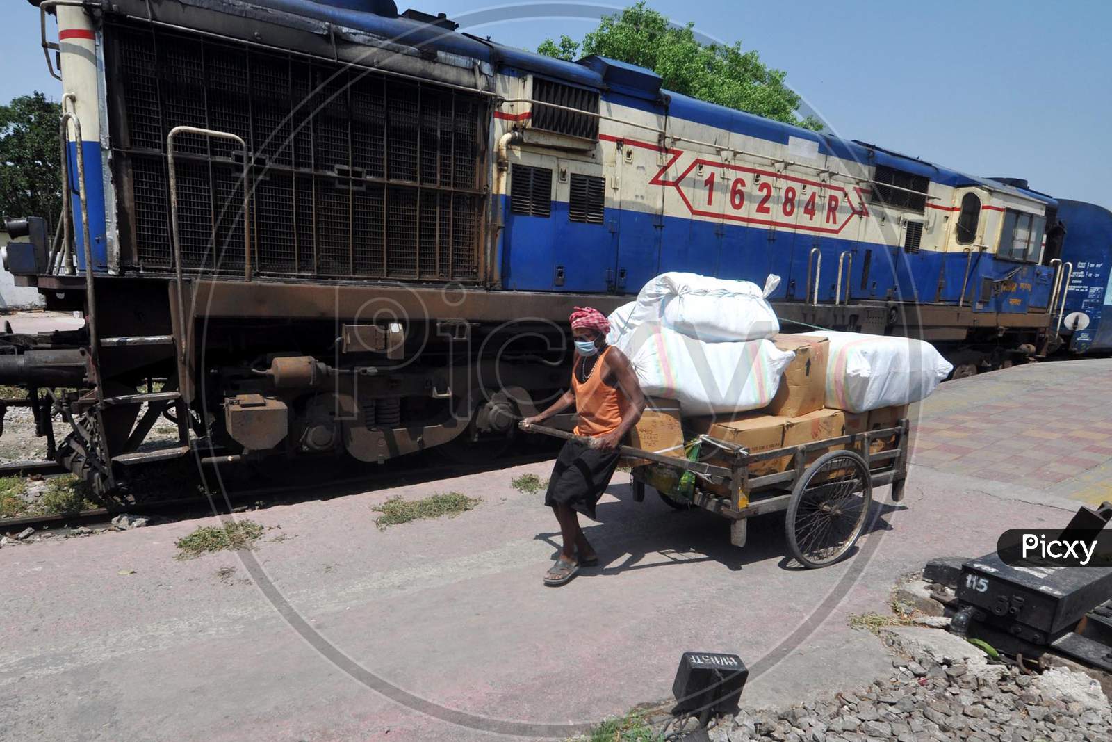 Man Pulling  Loaded  Hand Cart At a Railway station During a Nation Wide Lock down For Corona Virus Or COVID-19 Pandemic In Guwahati, India . April 16,2020