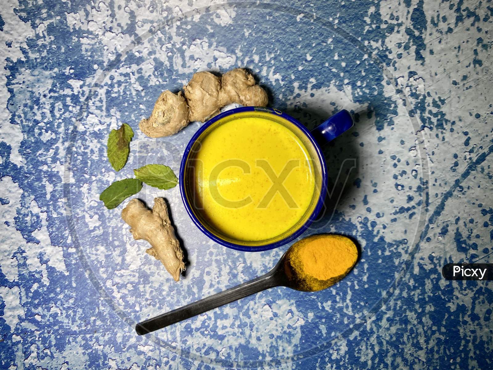 Turmeric milk with ginger and tulsi leaves