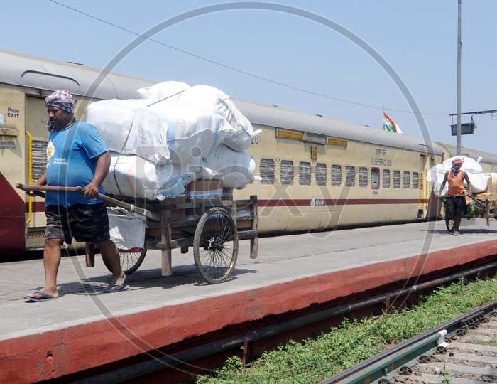 A Man Pulling  Loaded  Hand Cart At a Railway station During a Nation Wide Lock down For Corona Virus Or COVID-19 Pandemic In Guwahati, India . April 16,2020