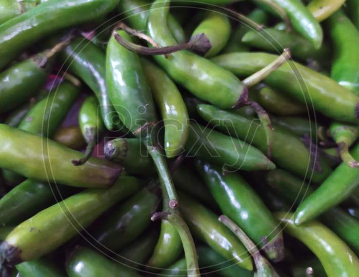 Green Chilies Closeup Forming a Background