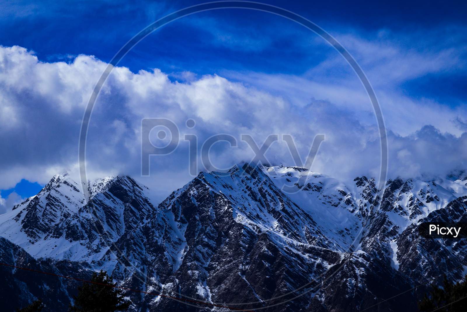 Snow covered Mountains with Blue sky and clouds in india