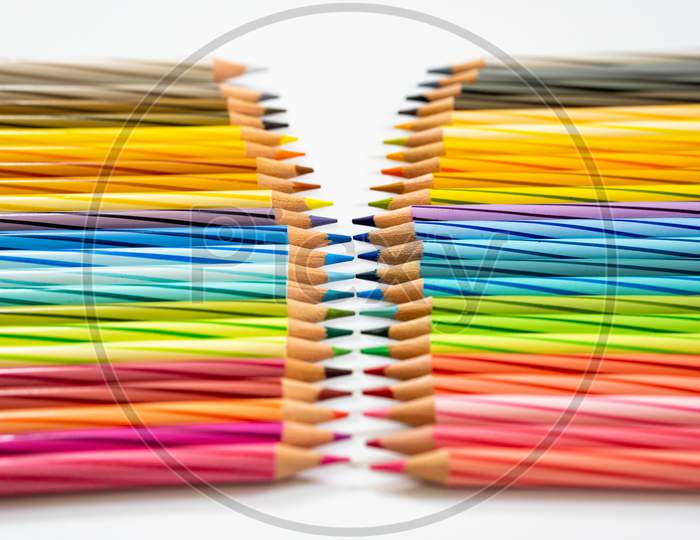 Color Pencils arranged in a line On white Background
