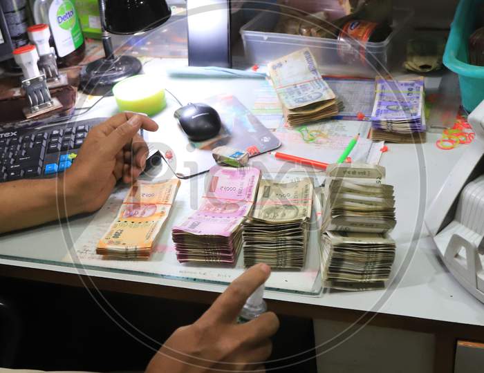 A Bank Employee Sanitize Indian Currency In Side A Bank During A Nationwide Lockdown To Slow The Spreading Of The Coronavirus Disease (Covid-19), In Prayagraj, April, 17, 2020.