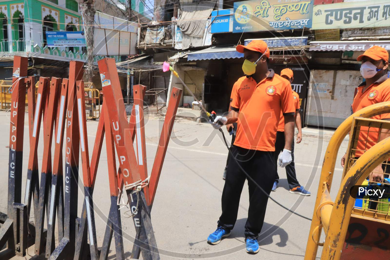Sdrf Jawans Spray Sanitizer On The Road Side Barricades During A Nationwide Lockdown To Slow The Spreading Of The Coronavirus Disease (Covid-19), In Prayagraj, April, 17, 2020.