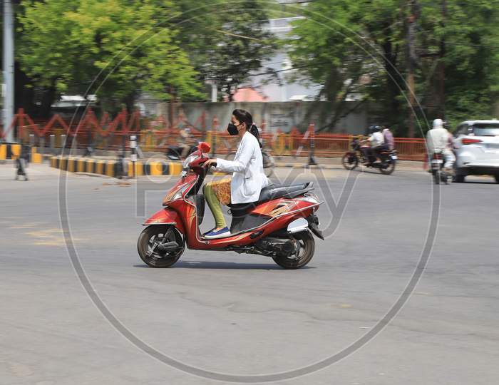 A Lady Doctor Rides Scooty On The Road During A Nationwide Lockdown To Slow The Spreading Of The Corona virus Disease (Covid-19), In Prayagraj, April, 17, 2020.