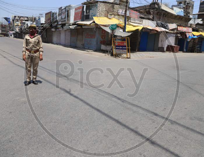 A Woman Police On Duty On The Empty Road  During A Nationwide Lockdown To Slow The Spreading Of The Coronavirus Disease (Covid-19), In Prayagraj, April, 17, 2020.
