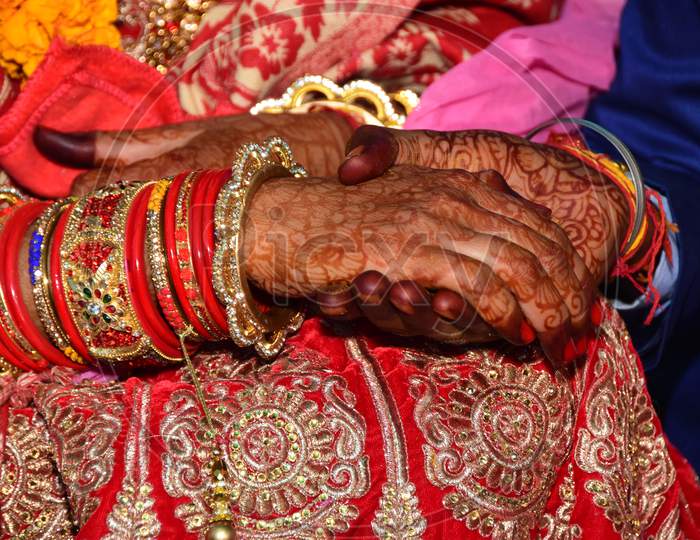 Hands of bride and groom in Indian wedding