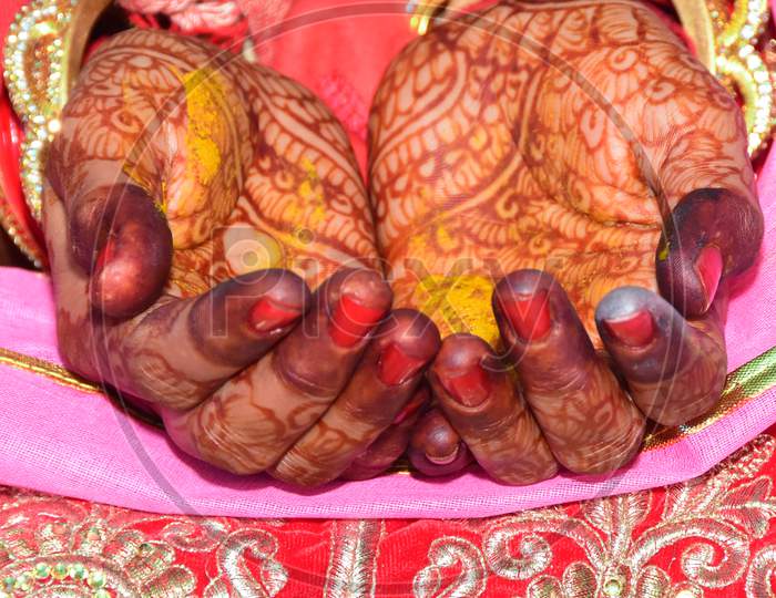 Hands of bride and groom in Indian wedding