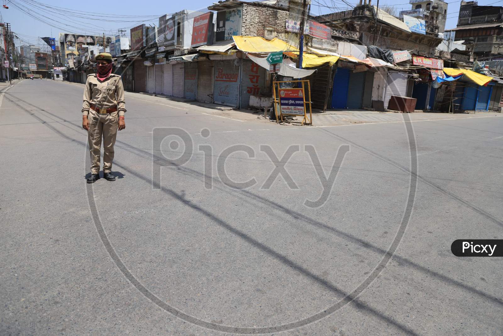 A Woman Police On Duty On The Empty Road  During A Nationwide Lockdown To Slow The Spreading Of The Coronavirus Disease (Covid-19), In Prayagraj, April, 17, 2020.