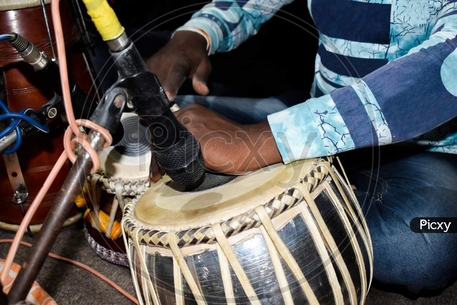 close up image of a musician hand playing tabla