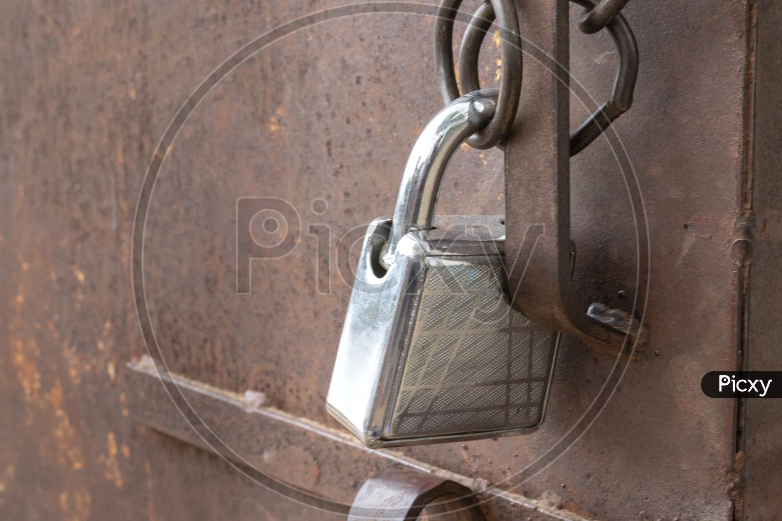 Image of a padlock used to protect a closed metal door