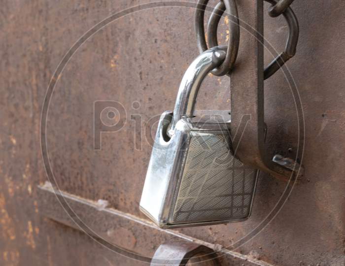 Image of a padlock used to protect a closed metal door
