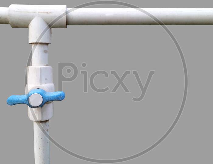 PVC water pipe fitting, joint in 'T' junction with plastic valve isolated image in grey background