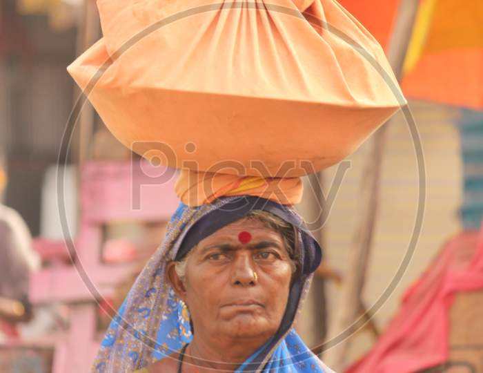 A woman carrying weight on her head