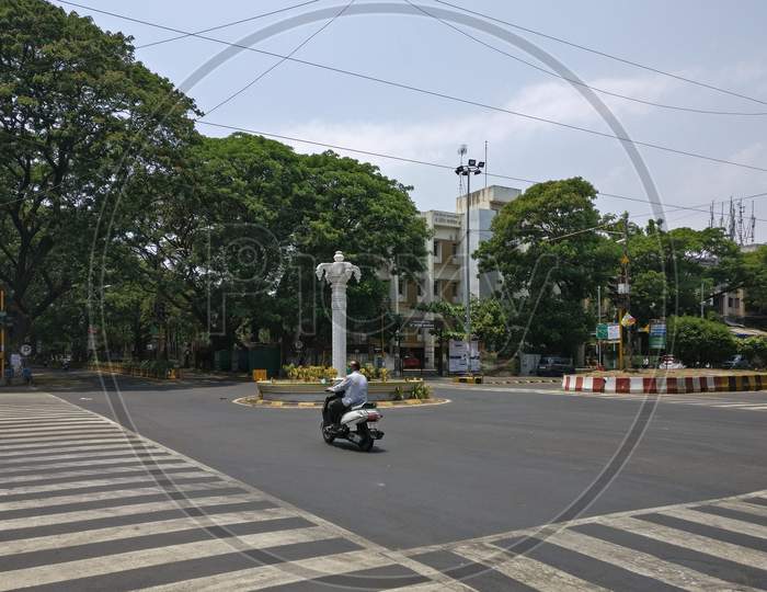Man driving alone on Empty Streets and Public Lockdown due to coronavirus covid 19 pandemic. Pune, Maharashtra, India