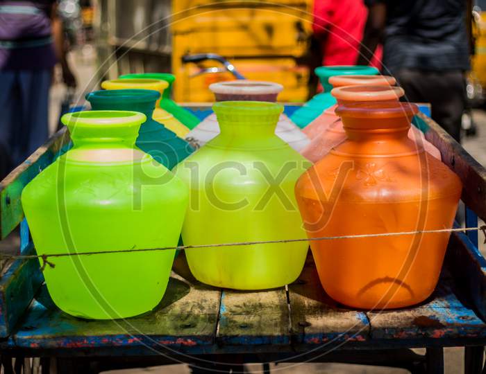Multicolor Plastic Water Canister Filled Metro Water And Which Its Transport In Tricycle Auto Richshaw And Water Back To Their Homes Where It Is Used For Drinking, Hygiene And Other Necessary Uses.