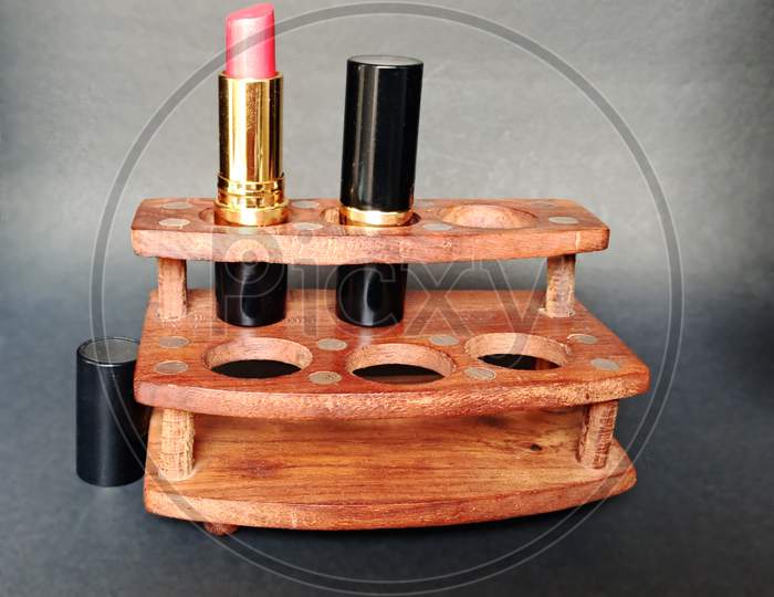 Lipsticks in a wooden handicraft holder.