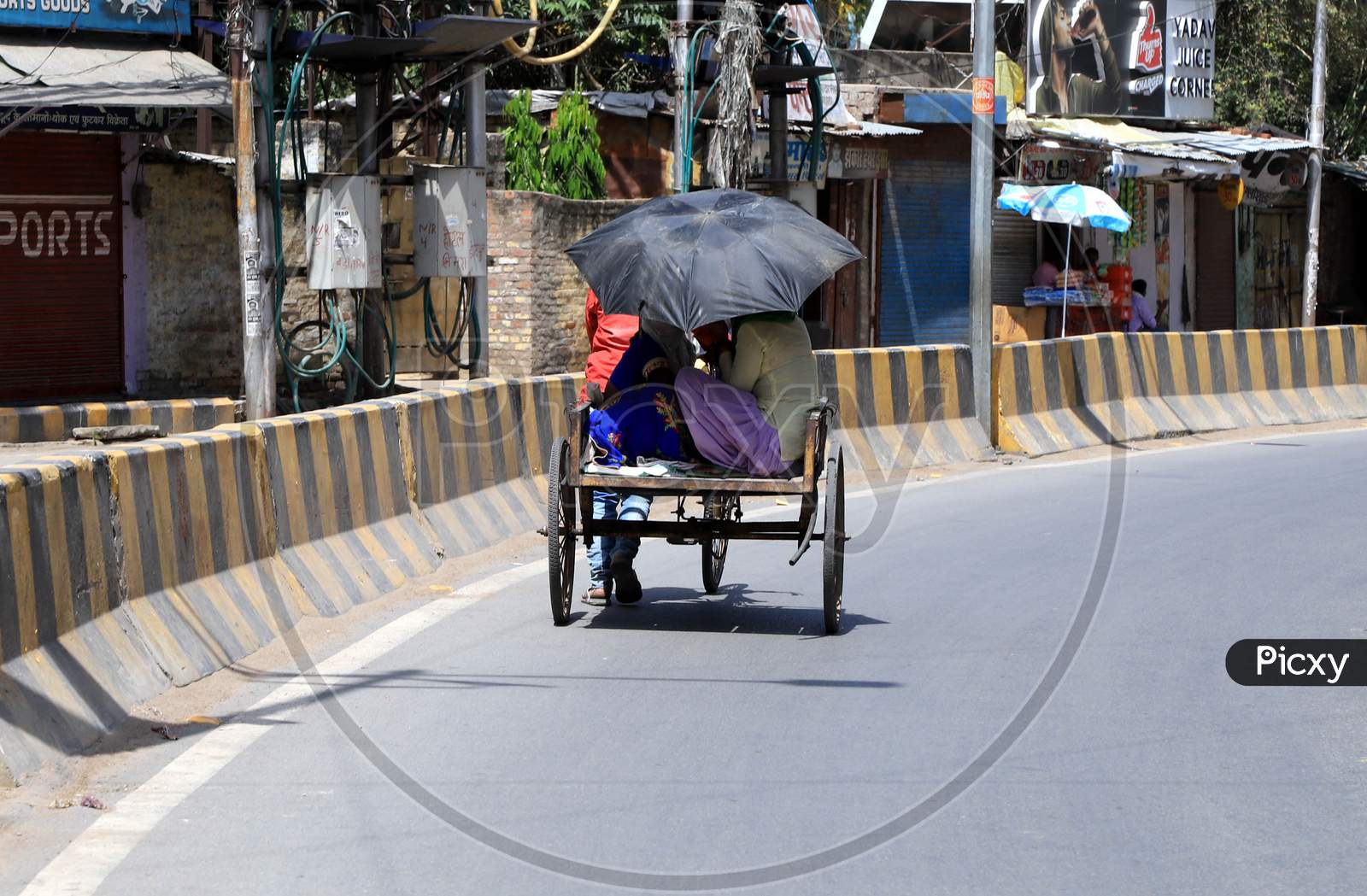 Women Ride on  Trolly On Road During A Nationwide Lockdown To Slow The Spreading Of The Coronavirus Disease (Covid-19), In Prayagraj, April, 18, 2020.