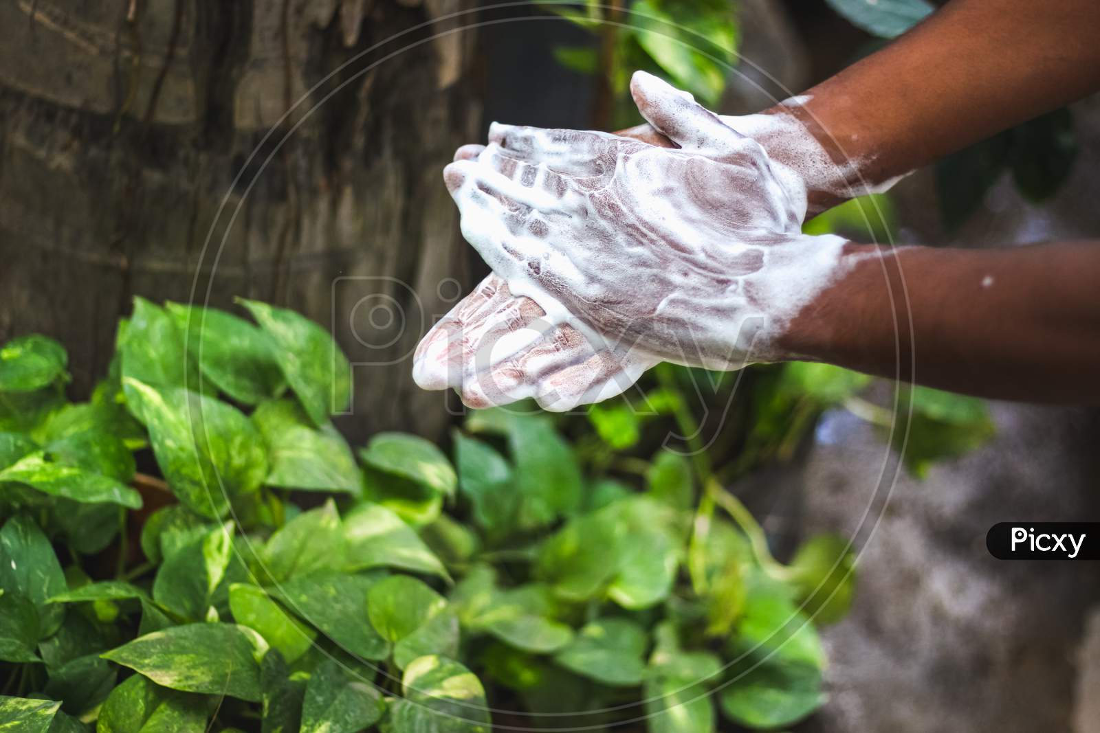 Washing Hands.Man Washing His Hands In The Garden At Home.Coronavirus Pandemic Prevention Wash Hands With Soap Warm Water And , Rubbing Nails And Fingers Washing Frequently. Hygiene & Cleaning Hands.