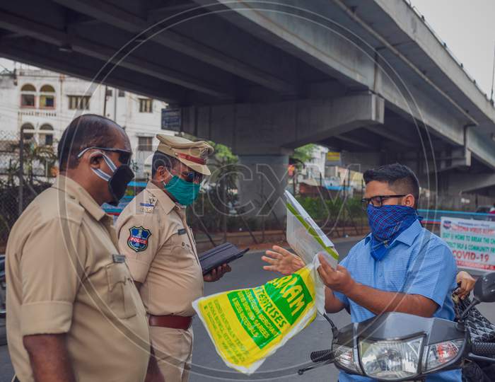 Citizen showing his medical reports to police officers on duty during lockdown amid coronavirus or covid 19 outbreak in india