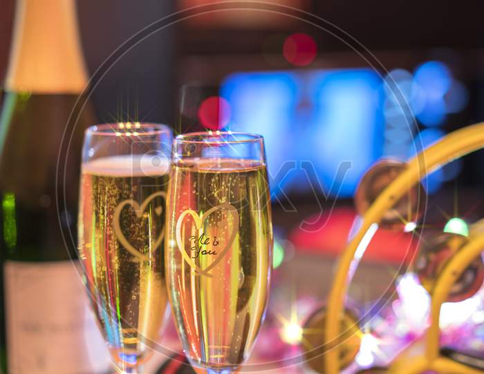 Black Microphone In Karaoke Club, With Champagne Bottle And Couple Of Sparkling Wine Glasses, Yellow Tambourine And Screen For Singing Music On Romantic Stage Party.