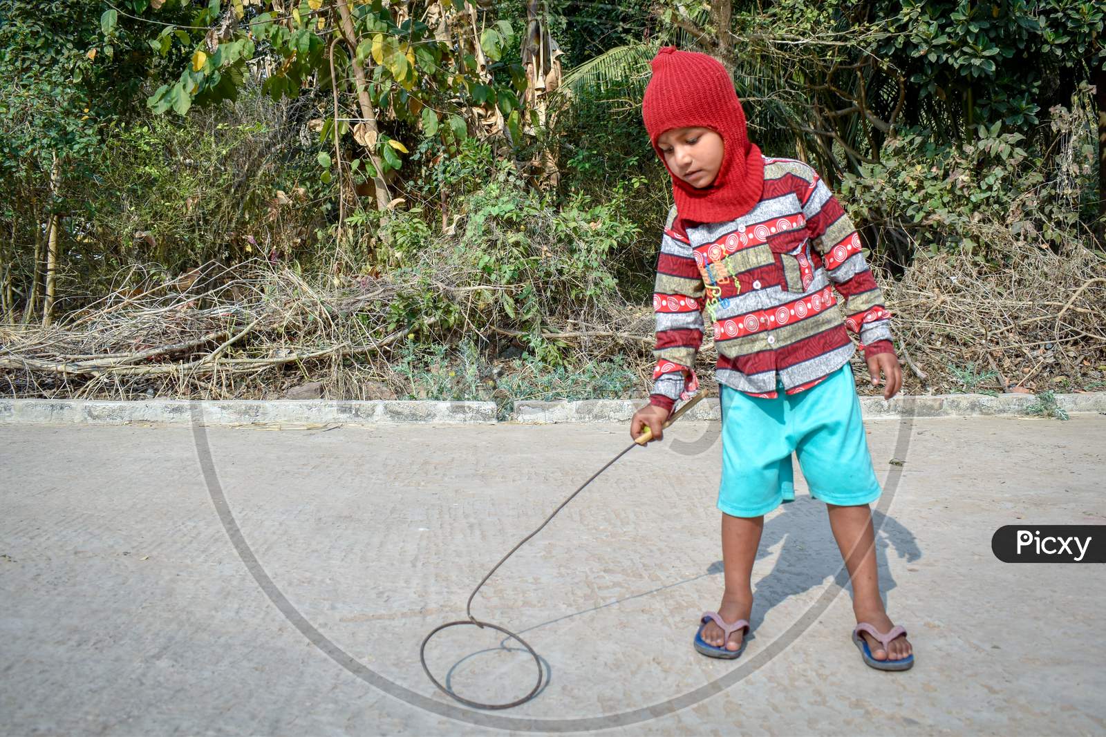 A 4-year-old poor child of a village is playing alone