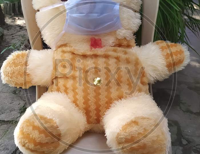Teddy bear toy wearing corona mask