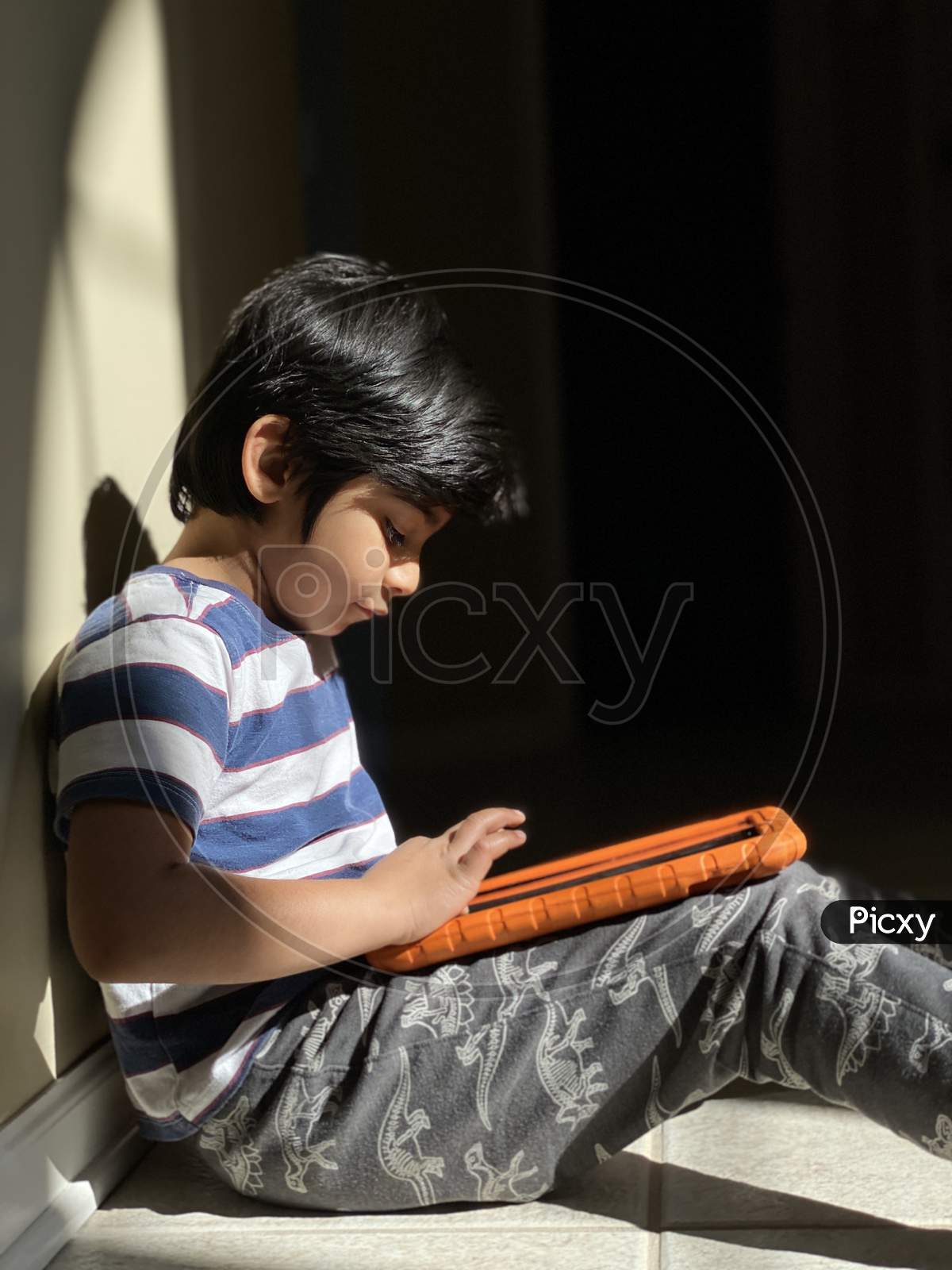 Pretty school boy studying homework math during her online lesson at home, social distance during quarantine, self-isolation, online education concept, home schooler