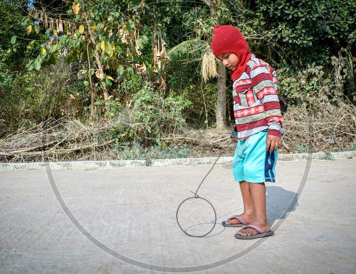 A 4-year-old poor child of a village is playing alone