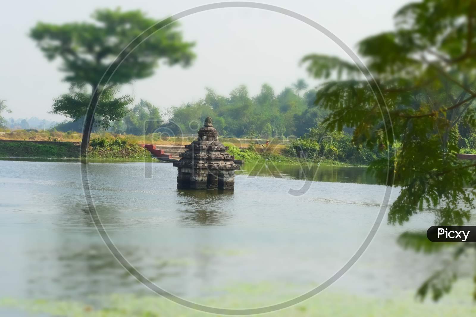 Religious Small temple surrounded by water.