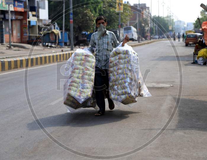 A Vendor Carry Food Walk On The Empty Road During A Nationwide Lockdown To Slow The Spreading Of The Coronavirus Disease (Covid-19), In Prayagraj, April, 19, 2020